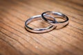 Wedding rings ÃÂ layingon natural wooden table or desk Royalty Free Stock Photo